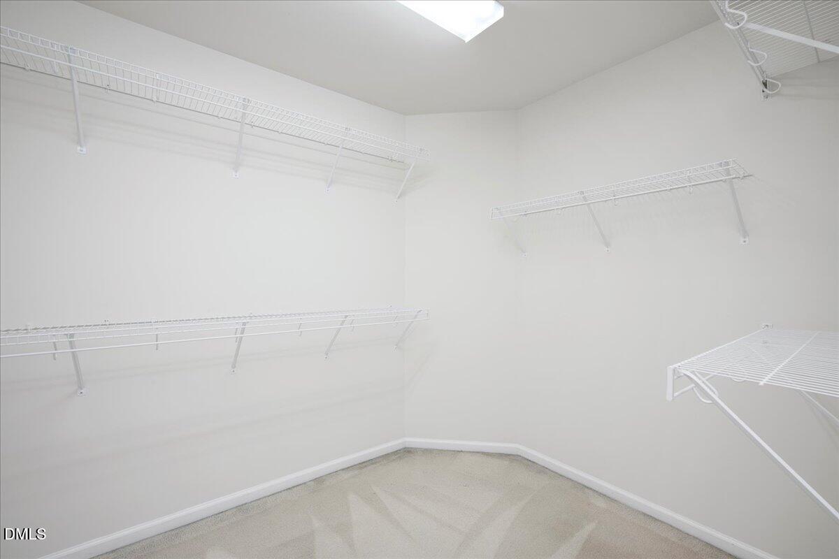 411 Amiable Loop Cary, NC 27519 - Photo 22 of 40 a view of a room with racks on the wall