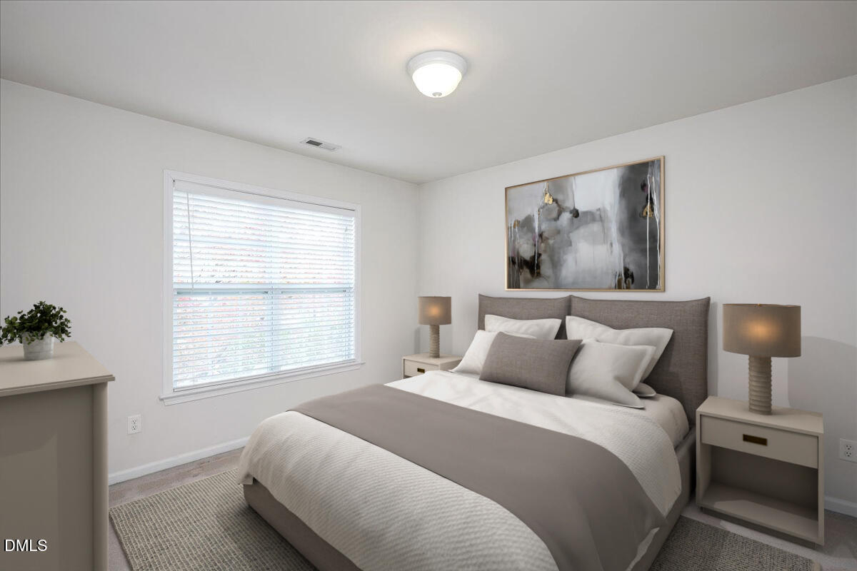 411 Amiable Loop Cary, NC 27519 - Photo 23 of 40 a bedroom with a bed and a window