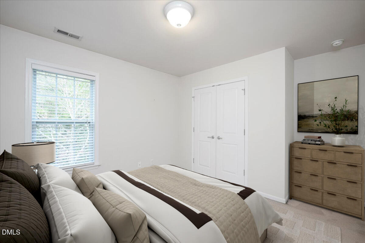 411 Amiable Loop Cary, NC 27519 - Photo 25 of 40 a bedroom with a bed and a window