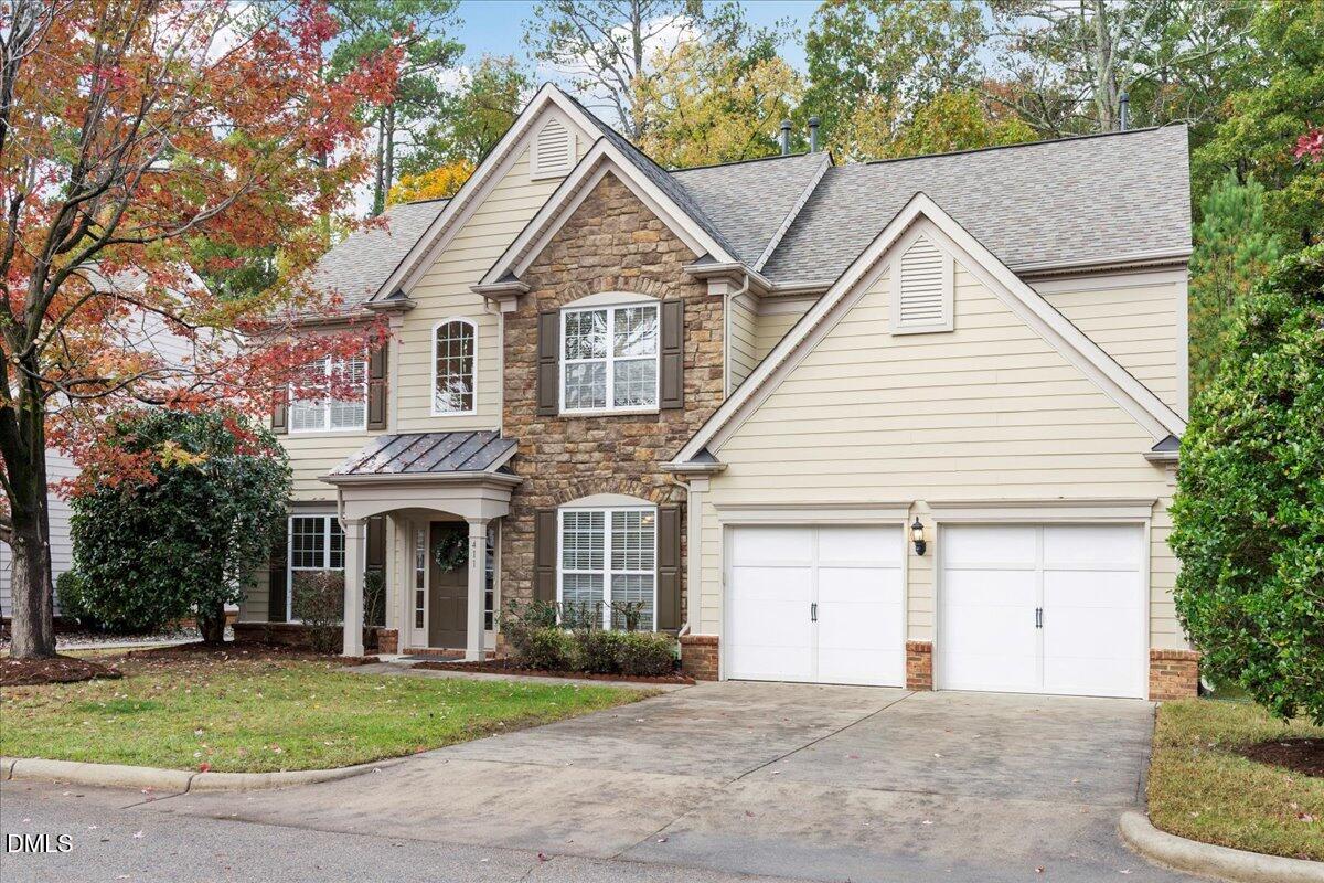 411 Amiable Loop Cary, NC 27519 - Photo 2 of 40 a front view of a house with a yard and garage