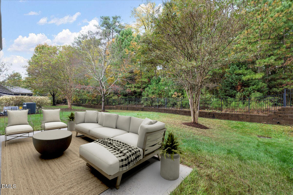411 Amiable Loop Cary, NC 27519 - Photo 30 of 40 a view of a patio with couches chairs and a yard with wooden fence