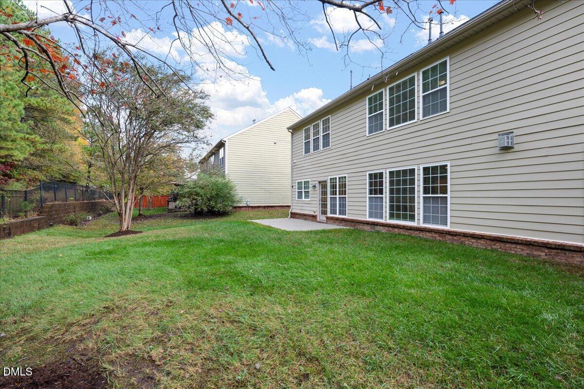 411 Amiable Loop Cary, NC 27519 - Photo 32 of 40 a view of a house with a backyard
