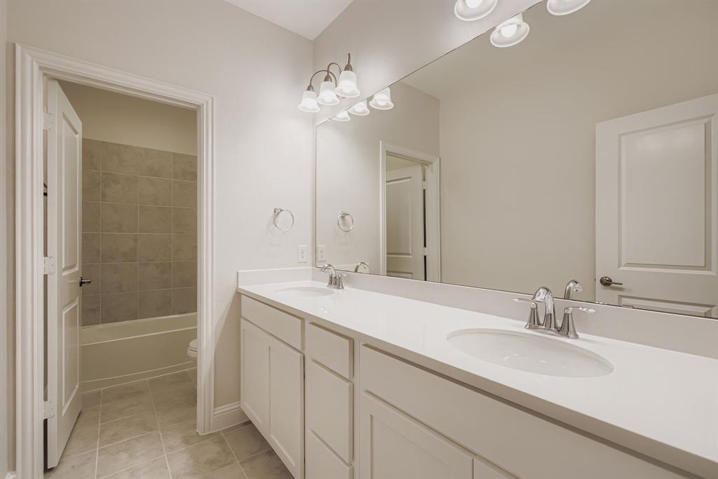 312 Magnolia Drive Oak Point, TX 75068 - Photo 18 of 28 Bathroom with light tile patterned floors, double vanity, and shower / bathtub combination