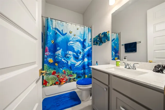 a bathroom with a sink mirror and vanity