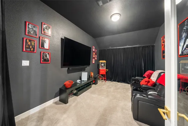 a bedroom with furniture and a flat screen tv