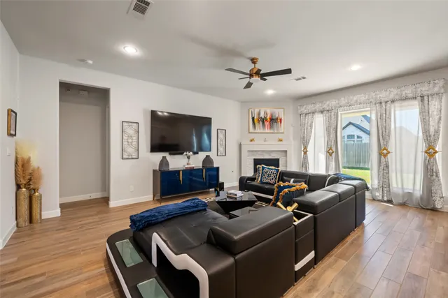 a living room with furniture fireplace and a flat screen tv
