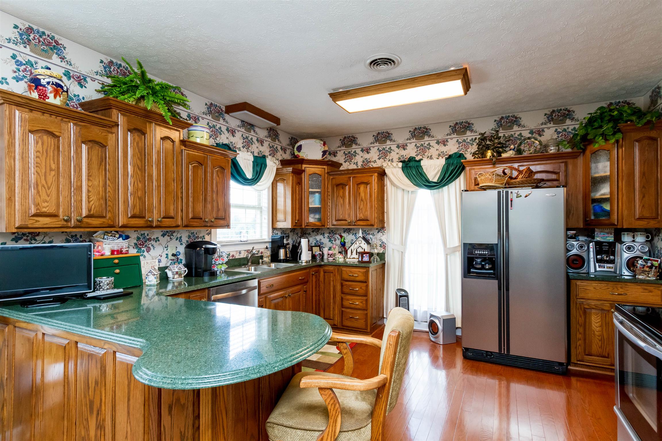 3611 Legacy Drive Springfield, TN 37172 - Photo 9 of 26 a kitchen with stainless steel appliances granite countertop a sink a oven and a dining table