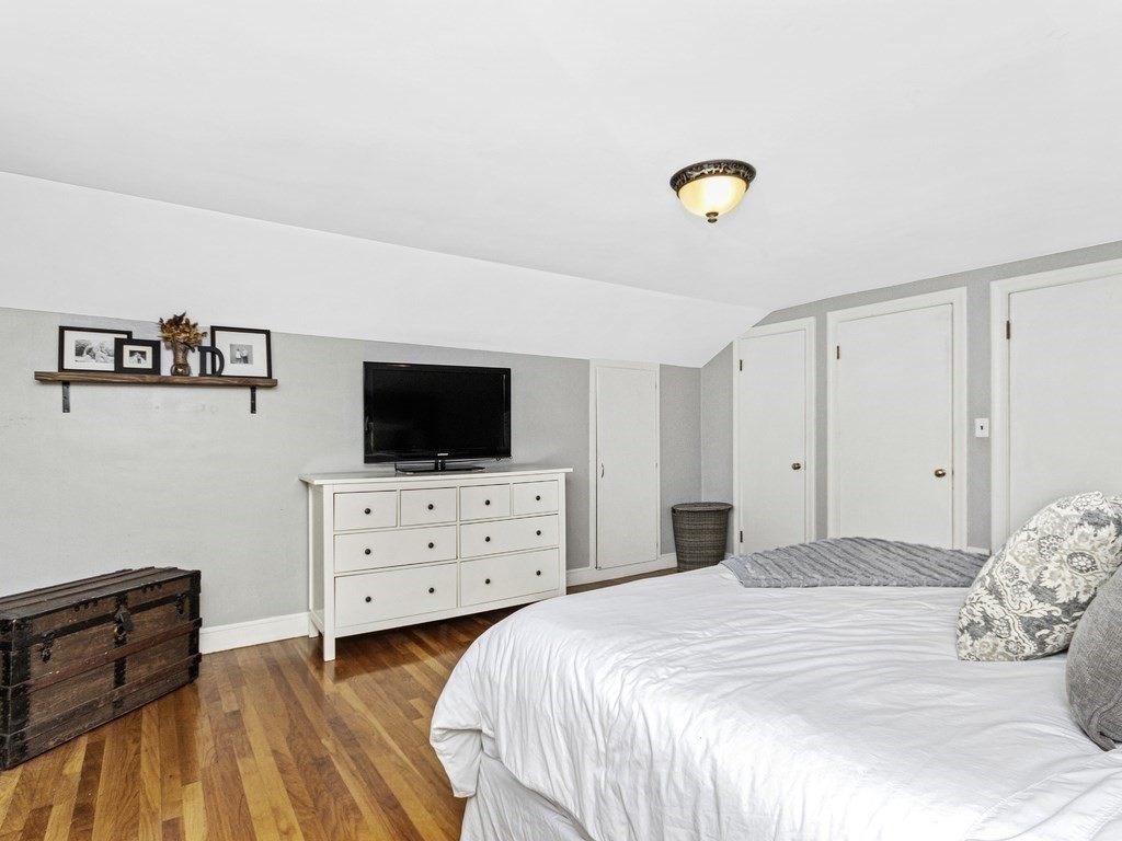 314 Florence Road Waltham, MA 02453 - Photo 17 of 40 a bedroom with a bed and a flat screen tv