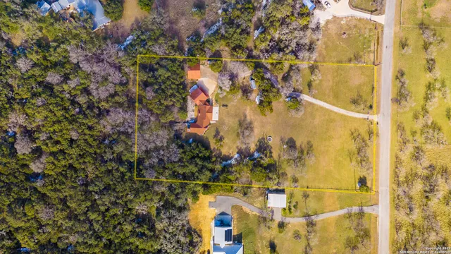 a view of a hallway with wooden floor and furniture