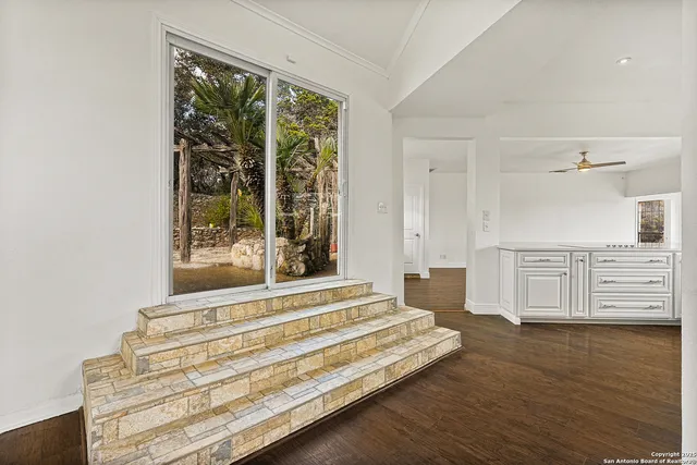 a kitchen with white cabinets white stainless steel appliances and sink