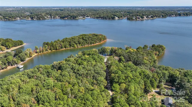 an aerial view of a houses with a lake view