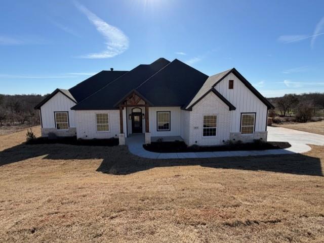 a front view of a house with a yard covered in snow