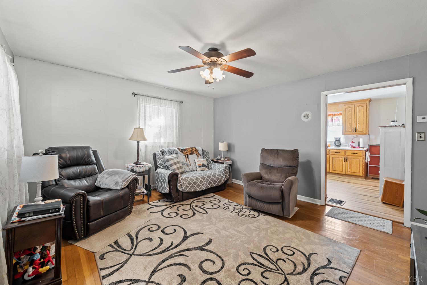 3169 Centerville Road Bedford, VA 24523 - Photo 15 of 25 a living room with furniture and a chandelier