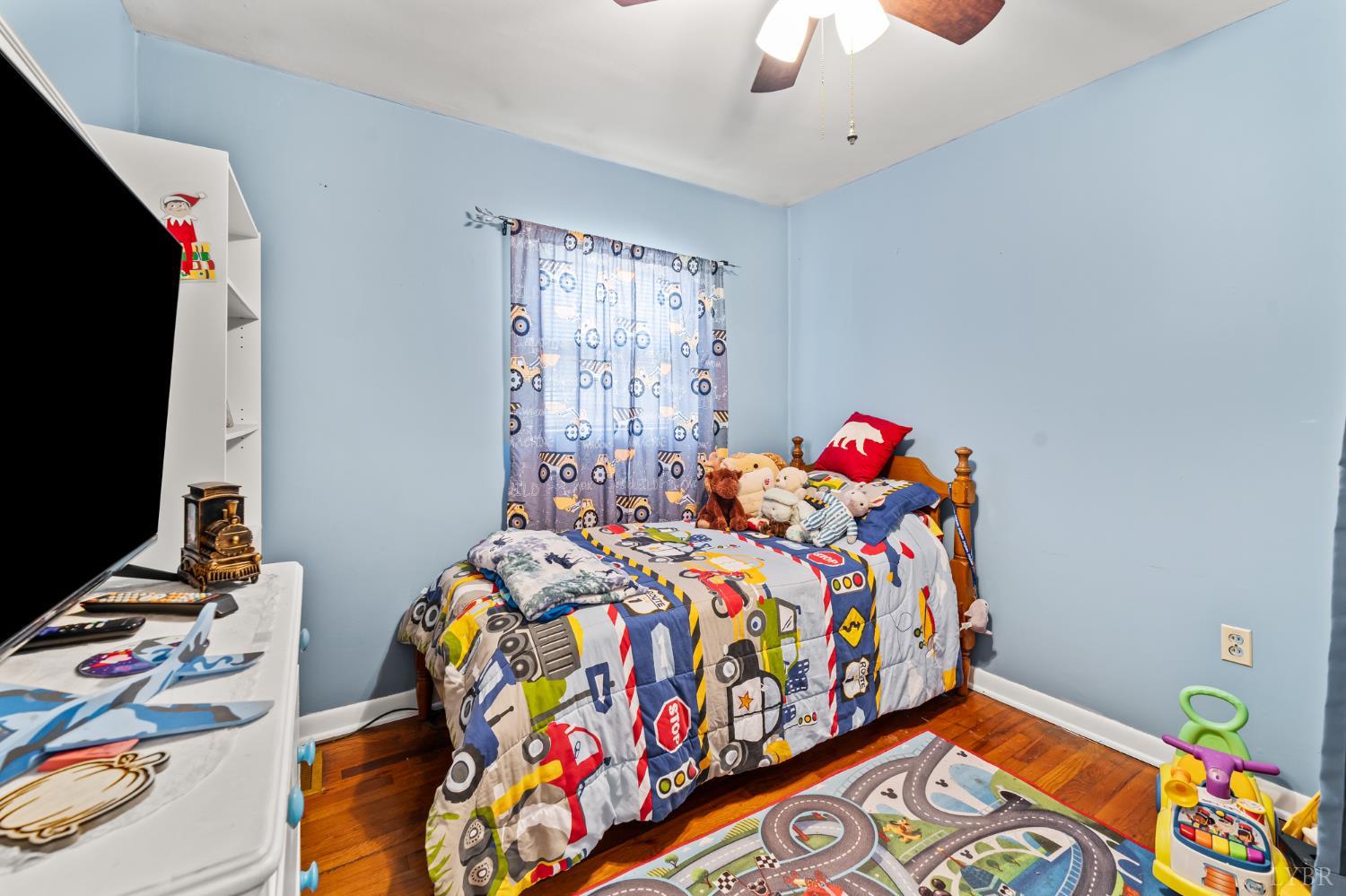 3169 Centerville Road Bedford, VA 24523 - Photo 20 of 25 a bedroom with bed and a flat tv screen on dresser