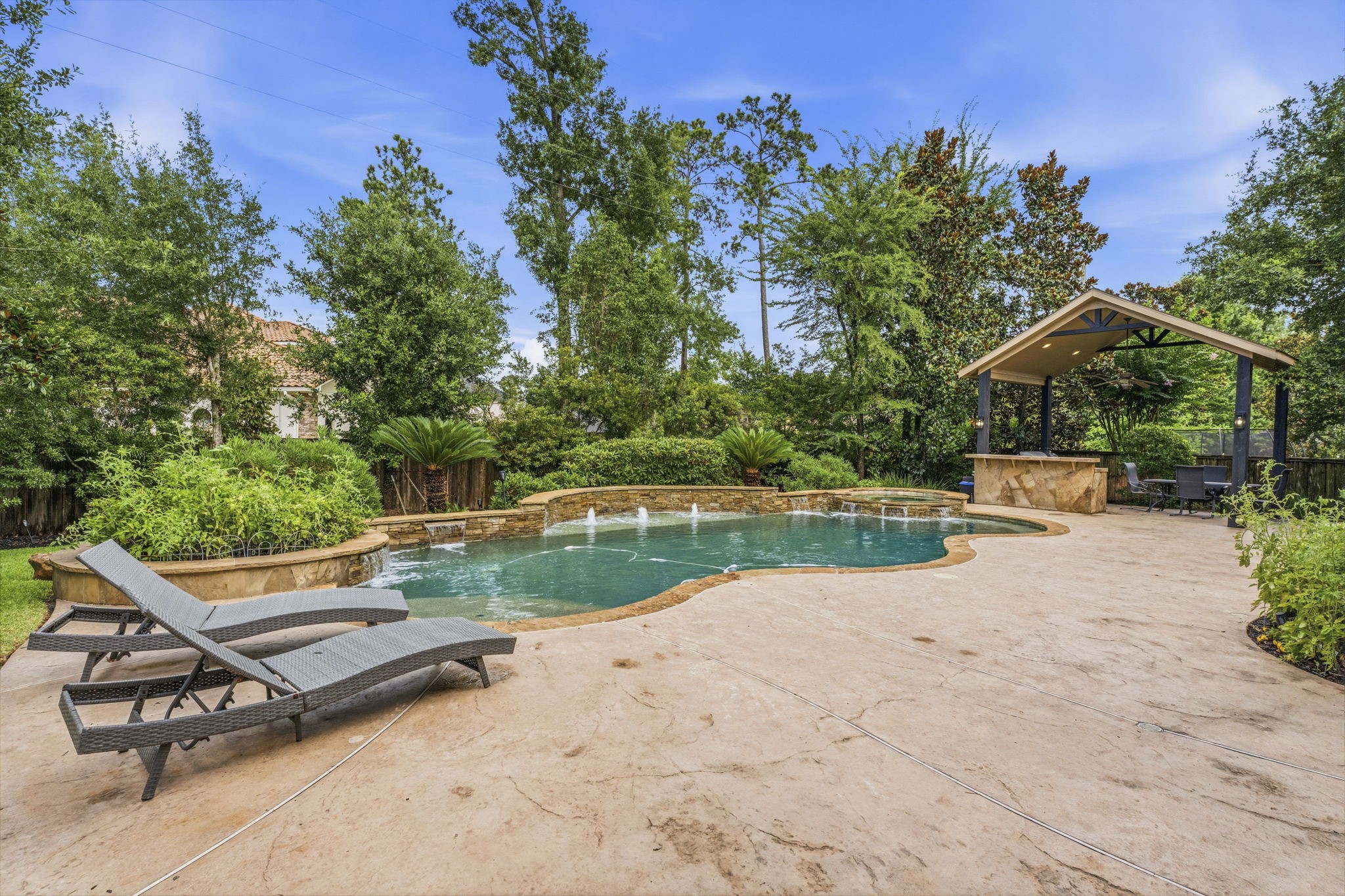 10 Spincaster Drive Spring, TX 77389 - Photo 2 of 38 Stunning pool with water features, multiple outdoor living spaces complete with outdoor kitchen and fireplace