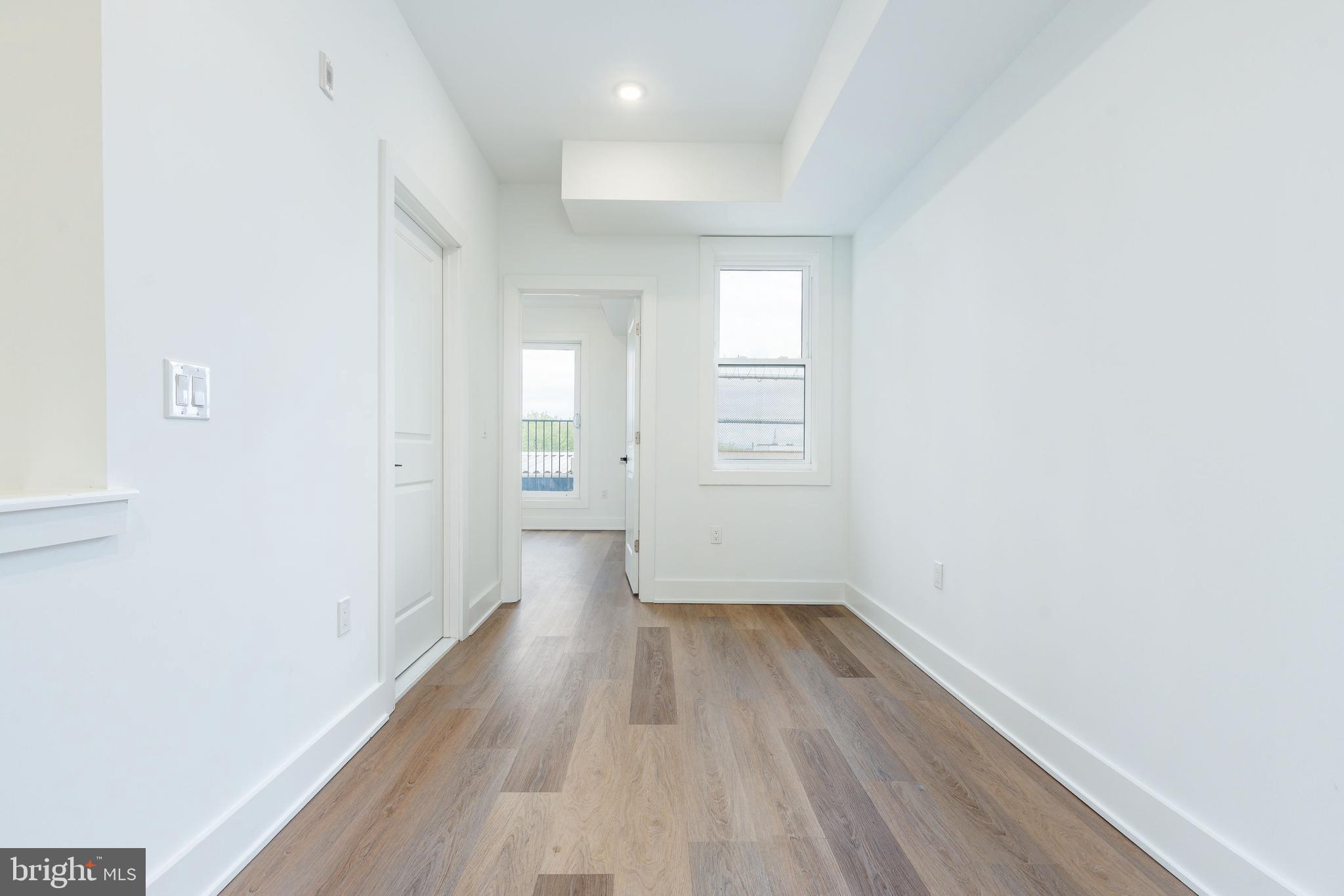 2252 North Front Street, Unit 2 Philadelphia, PA 19133 - Photo 3 of 15 a view of a room with wooden floor and window