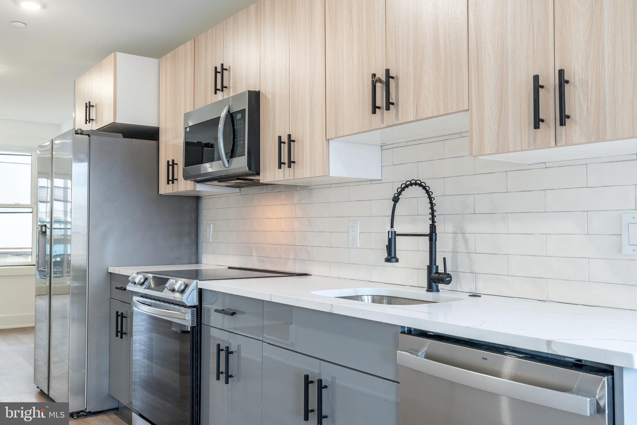 2252 North Front Street, Unit 2 Philadelphia, PA 19133 - Photo 7 of 15 a kitchen with stainless steel appliances a sink a stove and cabinets