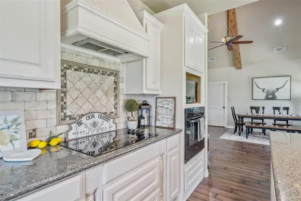 a kitchen with sink and chairs