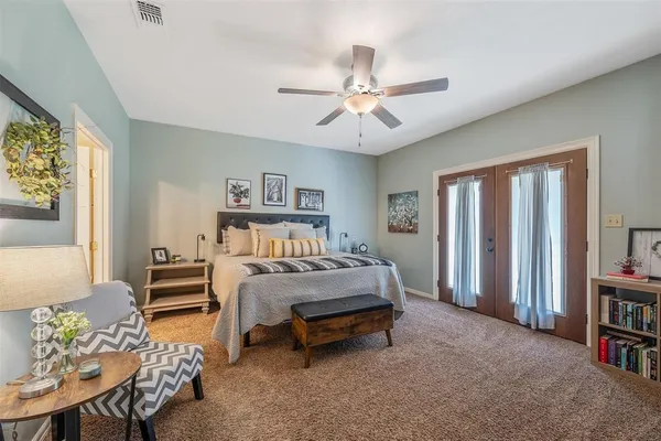 a bed sitting in a bedroom next to a window