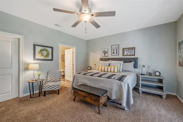 a bedroom with a bed and a chandelier