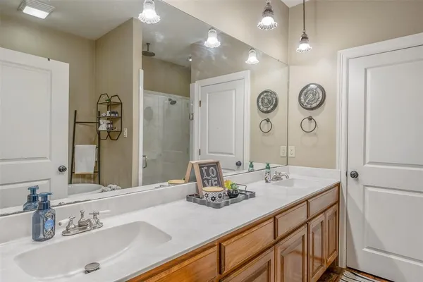 a bathroom with a sink double vanity and a mirror