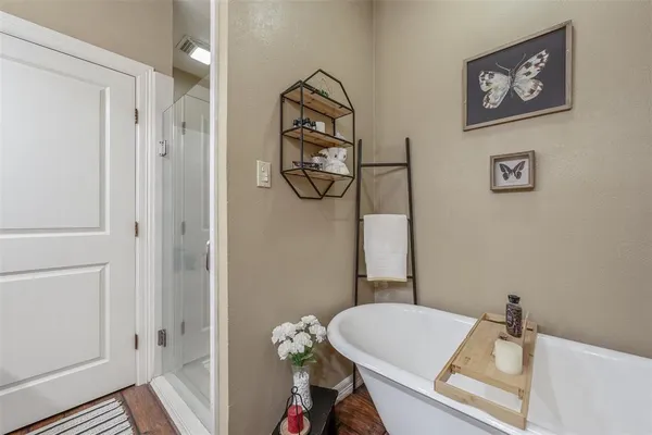 a bathroom with a granite countertop sink a toilet and a shower