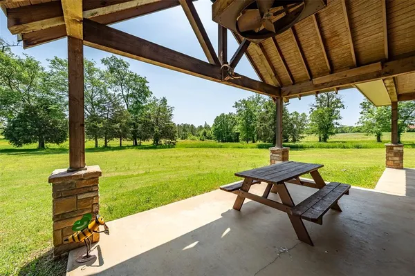 a view of a patio with a table chairs and a backyard