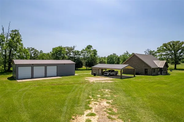 a view of a house with swimming pool and a yard