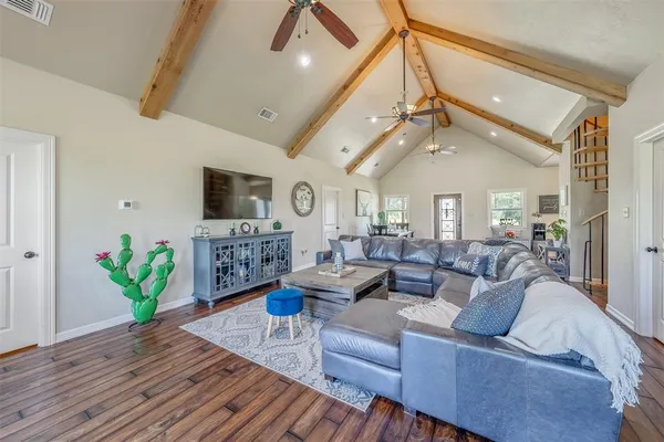 a living room with furniture a chandelier and a flat screen tv