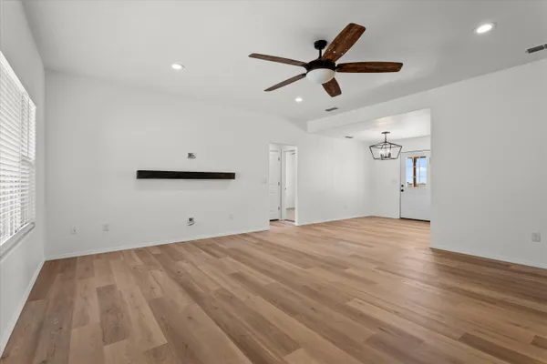 wooden floor in an empty room with a window