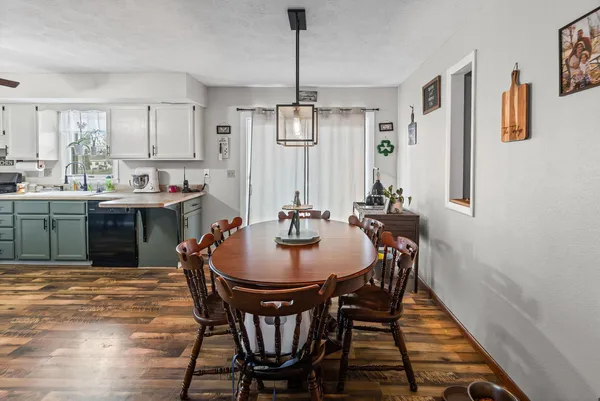 a dining room with furniture window and wooden floor