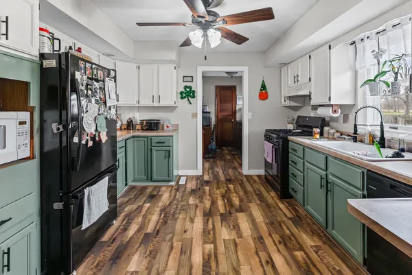 a kitchen with stainless steel appliances a refrigerator sink and wooden cabinets
