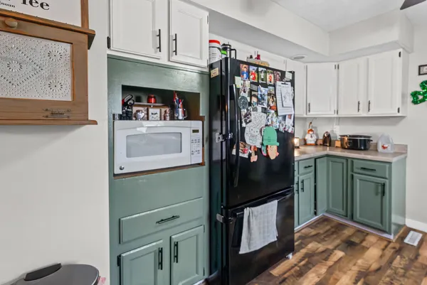 a kitchen with a refrigerator and cabinets