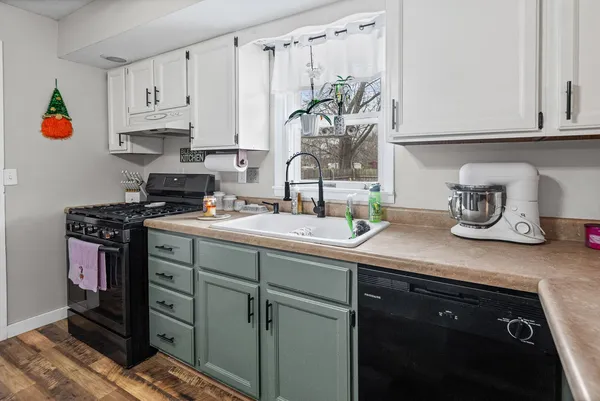 a kitchen with stainless steel appliances a sink stove and cabinets