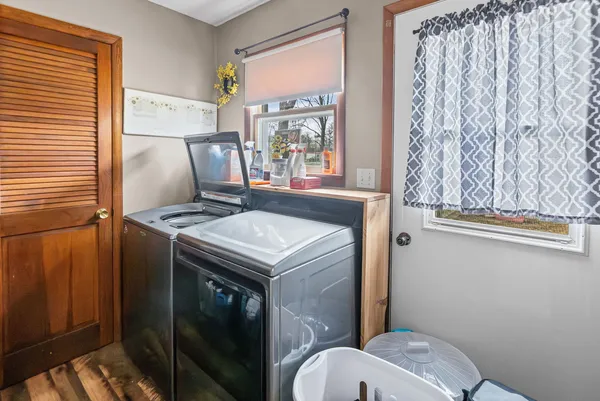 a bathroom with a sink toilet and window