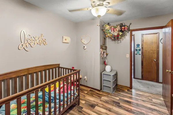 a view of a hallway with furniture and wooden floor