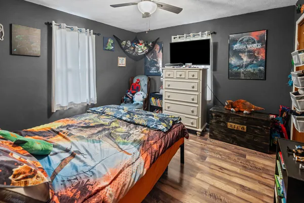 a bedroom with a bed and flat screen tv