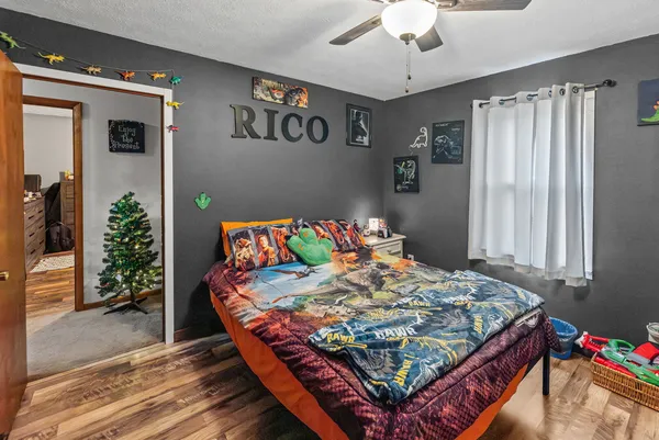 a bed sitting in a bedroom next to a window