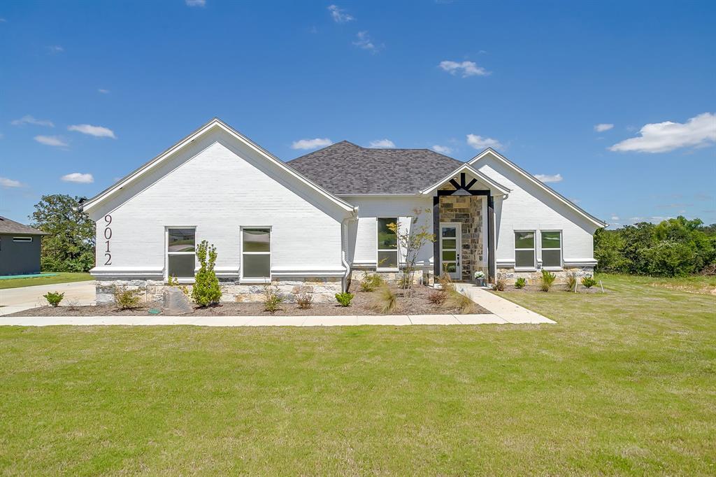 a view of house with backyard and swimming pool