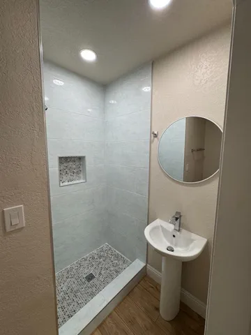 a bathroom with a toilet and a shower