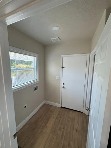a view of walk in closet with wooden floor