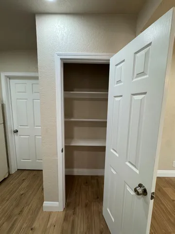 a view of a hallway with wooden floor