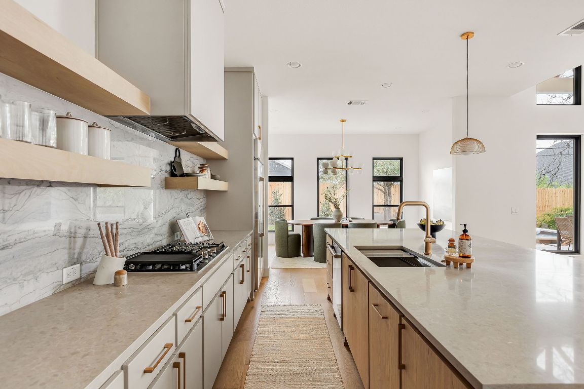 2607 Richcreek Road Austin, TX 78757 - Photo 11 of 40 a kitchen with stainless steel appliances a sink a stove and a wooden floors