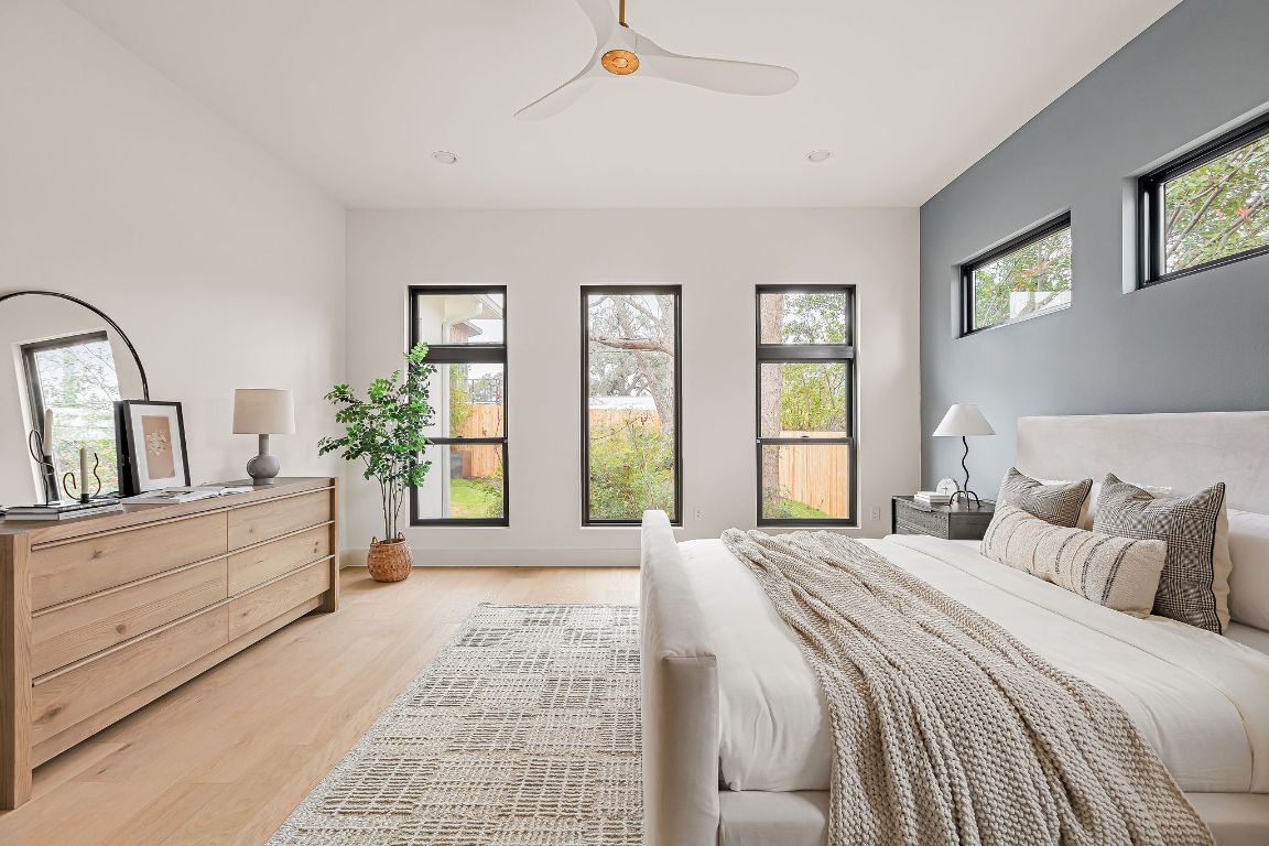 2607 Richcreek Road Austin, TX 78757 - Photo 16 of 40 a bedroom with a large bed and windows