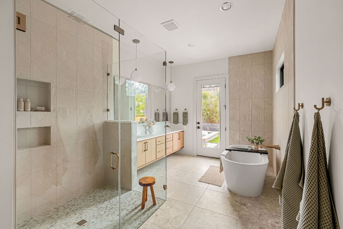 2607 Richcreek Road Austin, TX 78757 - Photo 17 of 40 a bathroom with a bathtub a sink and a shower
