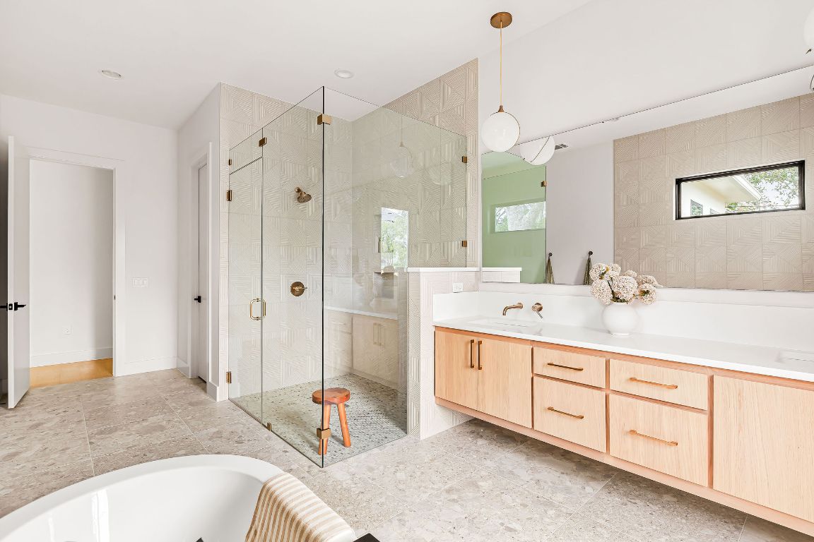 2607 Richcreek Road Austin, TX 78757 - Photo 19 of 40 a spacious bathroom with a tub sink double vanity and a mirror