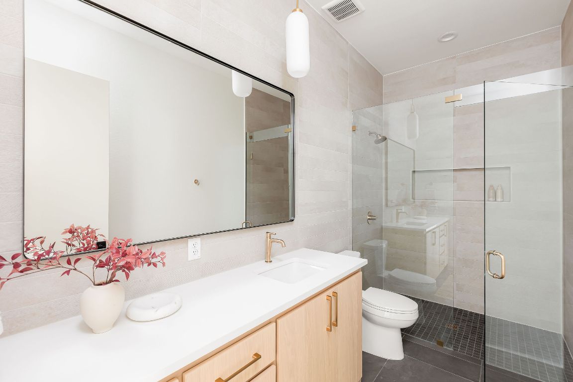 2607 Richcreek Road Austin, TX 78757 - Photo 28 of 40 a bathroom with a sink vanity mirror and toilet