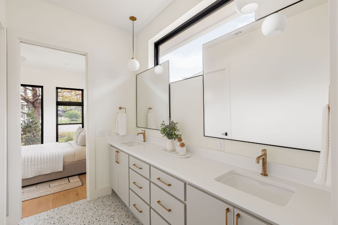 2607 Richcreek Road Austin, TX 78757 - Photo 37 of 40 a bathroom with 2 sink and a mirror