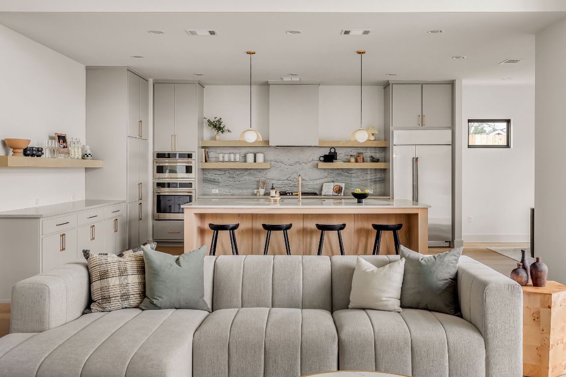 2607 Richcreek Road Austin, TX 78757 - Photo 7 of 40 a bedroom with a bed a couch and cabinets