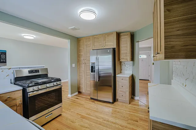 a kitchen with stainless steel appliances a stove a refrigerator and a oven